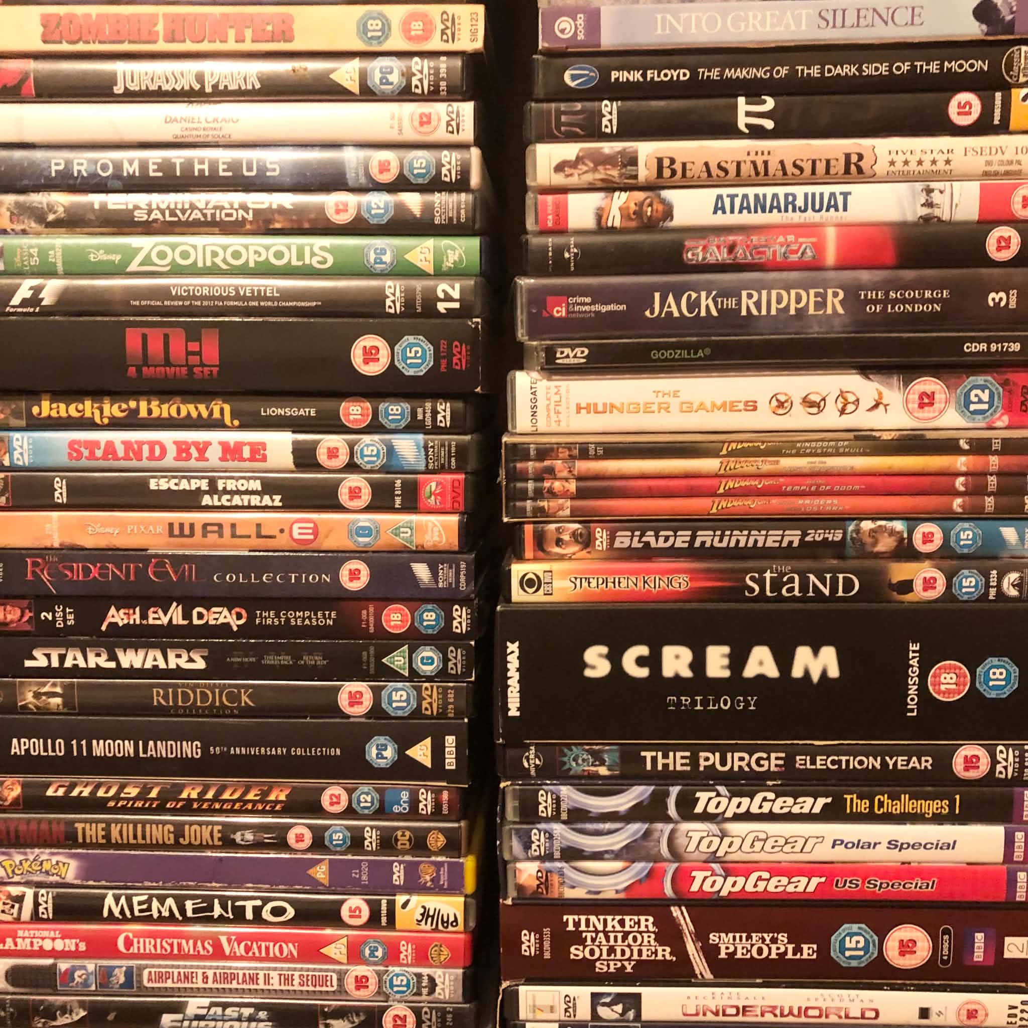 A photo of two stacks of a DVD collection, showing about 30 films.