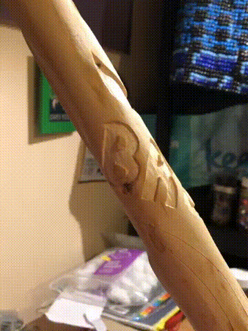 An animated gif, showing the name Bruce carved out in all capital, block letters, at an angle below the initial linework.