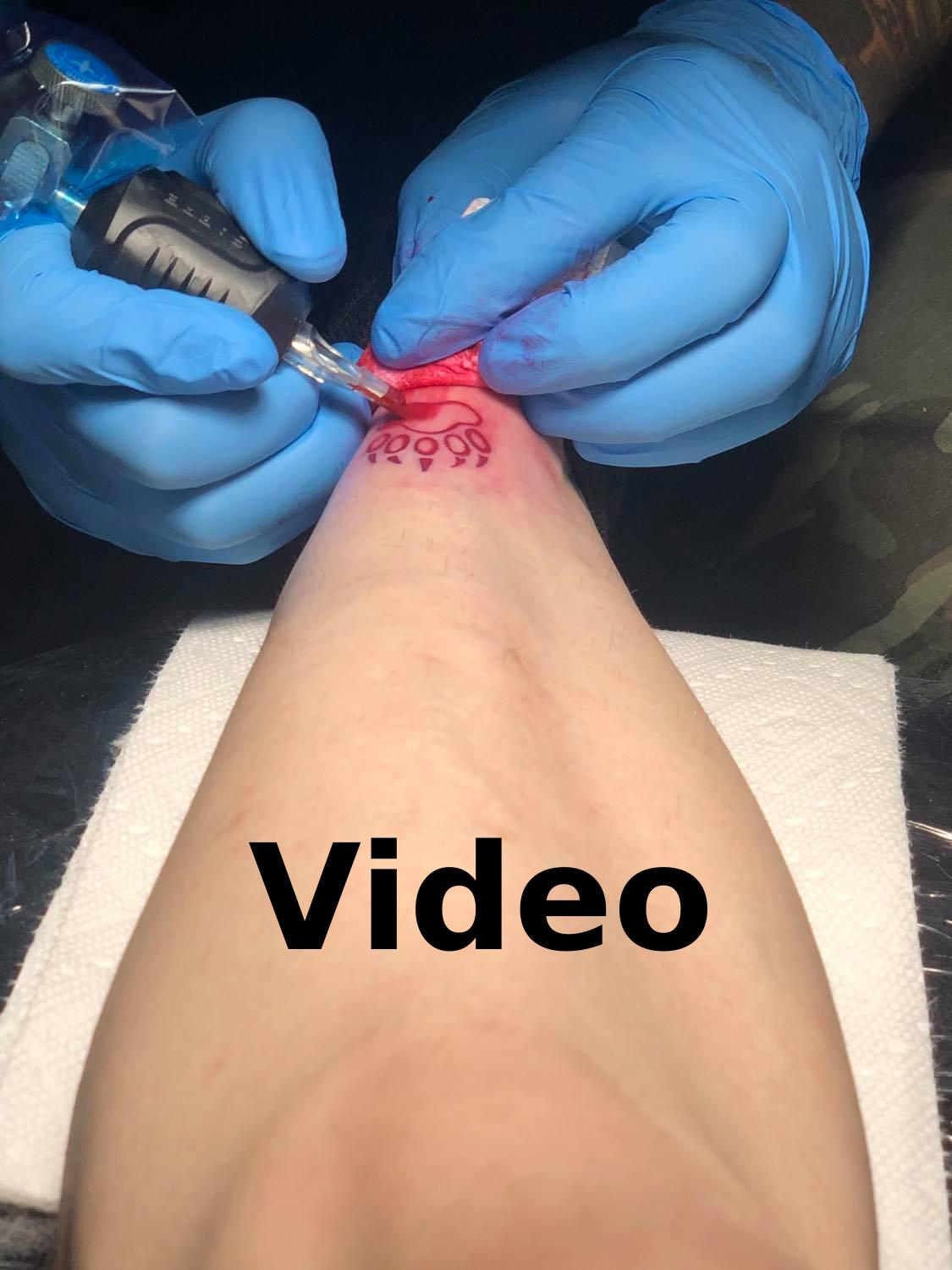 The tattoo beginning to be filled in, with the word 'Video' beneath.