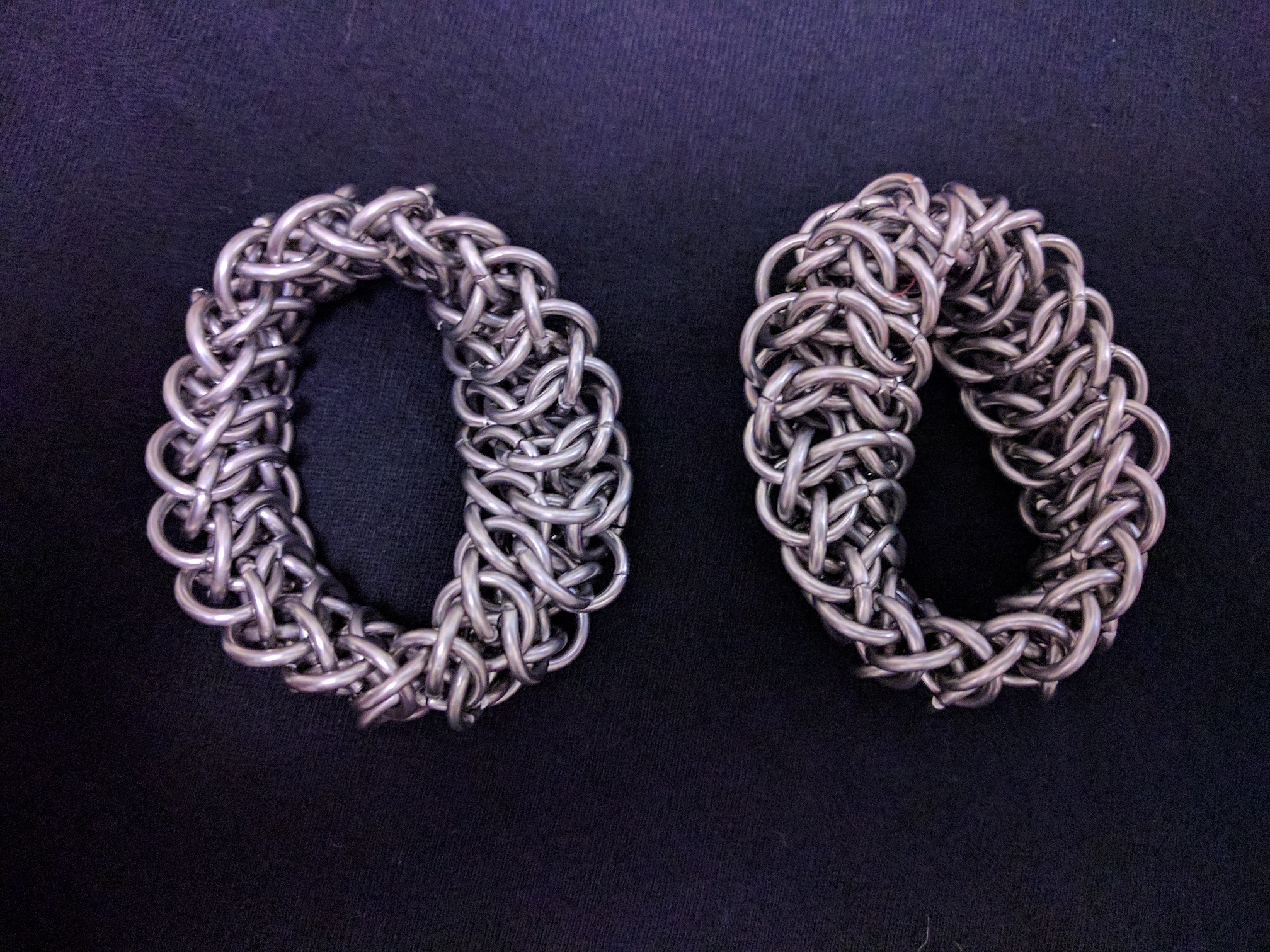 Two coils of a chainmaille mobius strip.