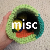 Looking into an open bag of juggling balls, the bag itself being knitted. The rug that it's on is actually crocheted by my grandfather
