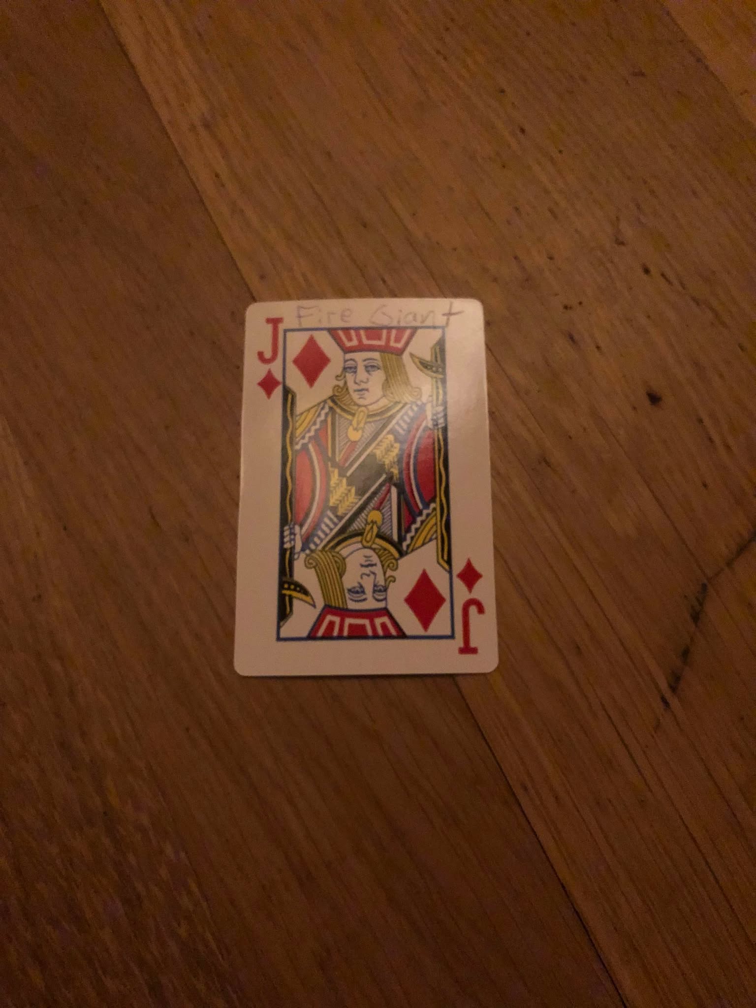 The jack of diamonds, thrown to the floor in front of the creature.