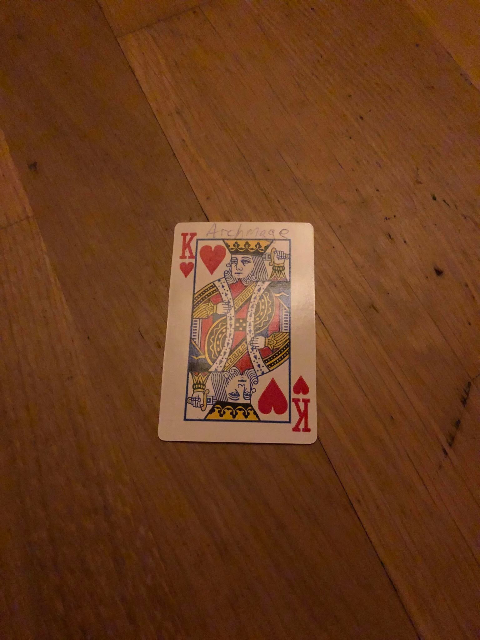 The king of hearts, thrown to the floor in front of the creature.