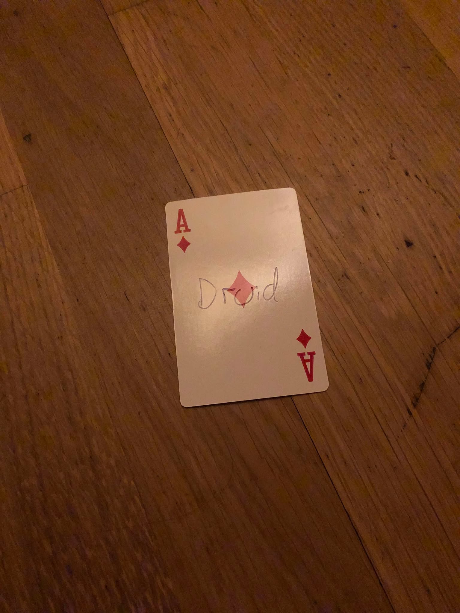 The ace of diamonds, thrown to the floor in front of the creature.