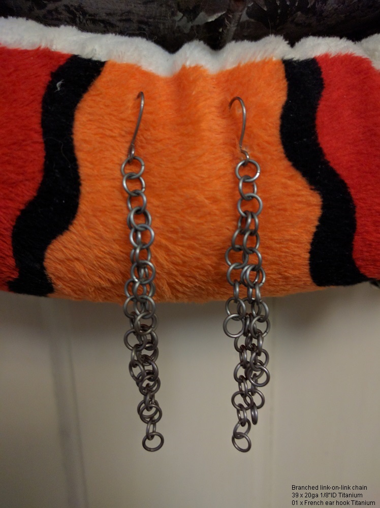The earrings, hanging from the orange snake stuffie again, mainly looking like dangling tiny rings.