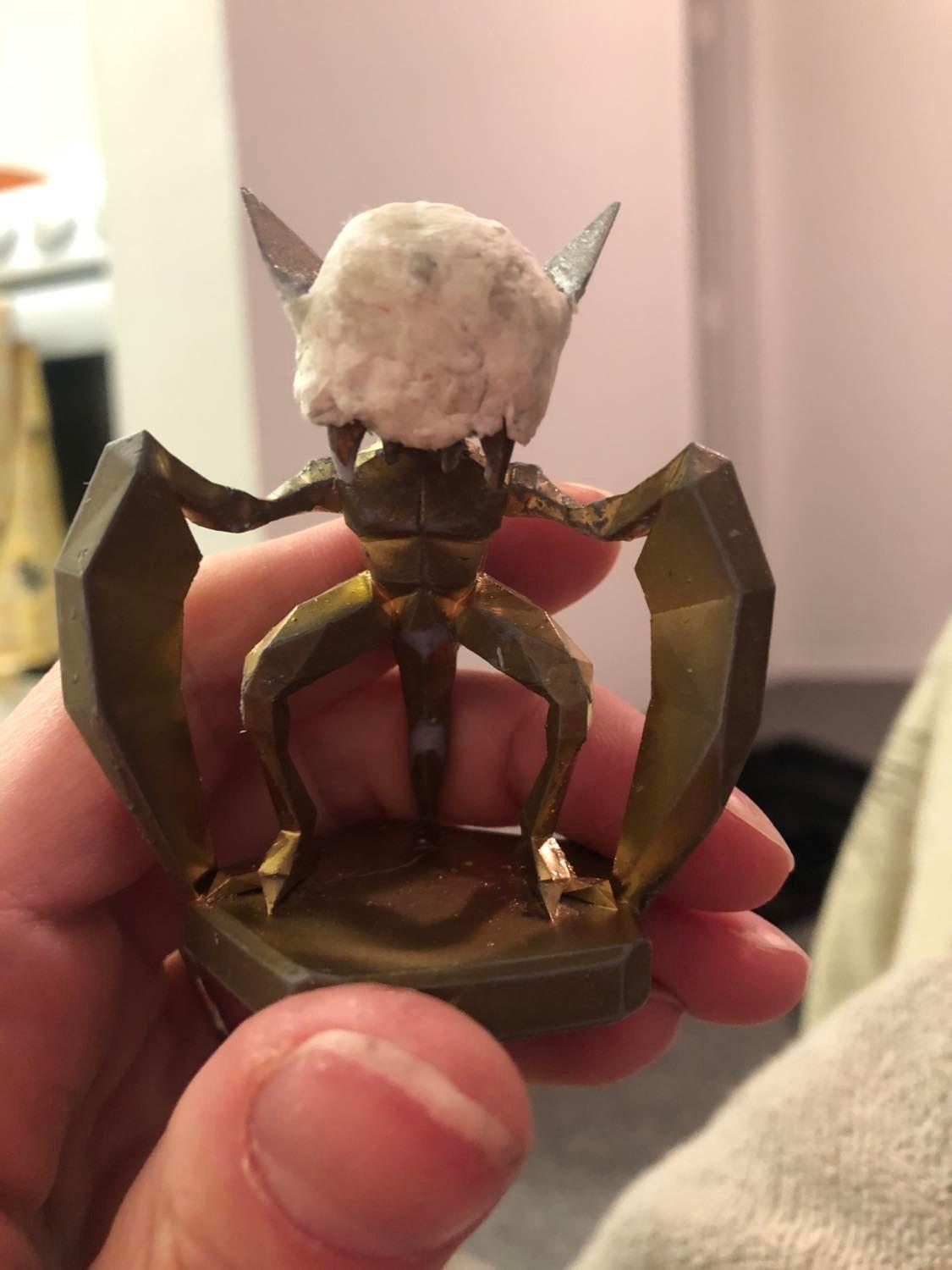 Kabutroid's head made with tissue balled and glued to create the round head, and the side planes from the original head are angled upwards to turn into Kabutroid's ears.