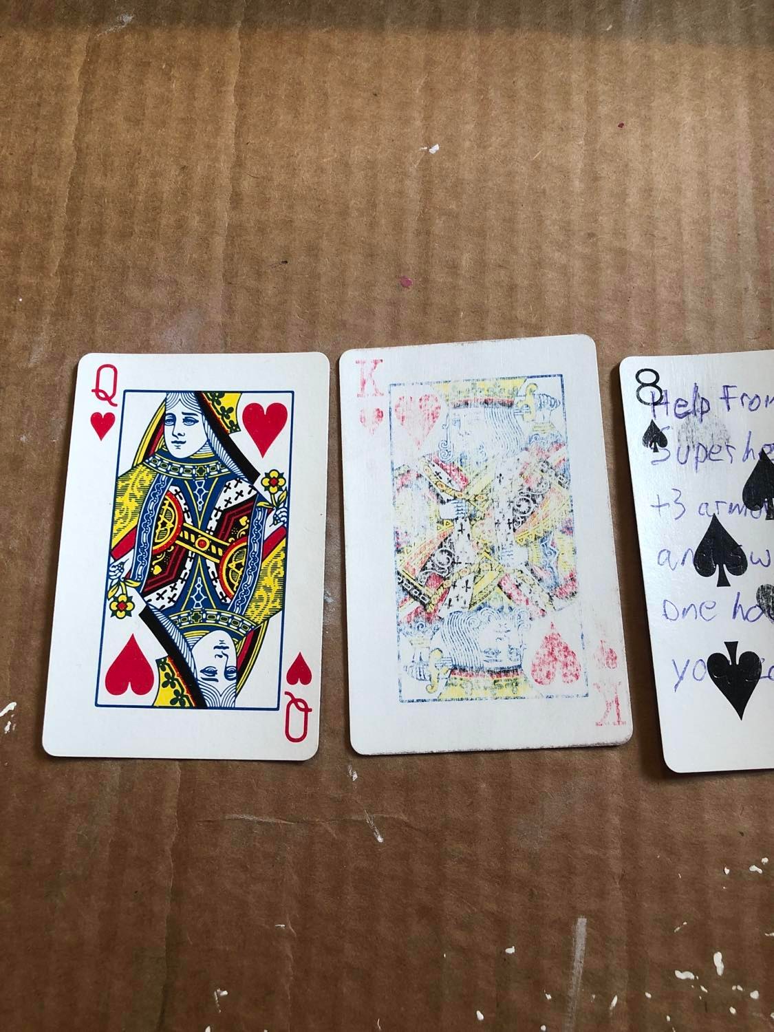 An unsanded card (Q of Diamonds, or the wish card smileyface), followed by the sanded king (which is mostly sanded down, also gain a magic item), followed by that eight of spades that's kinda partially sanded.