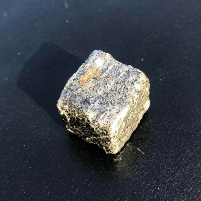 A metallic cube, with locations marked on the sides.