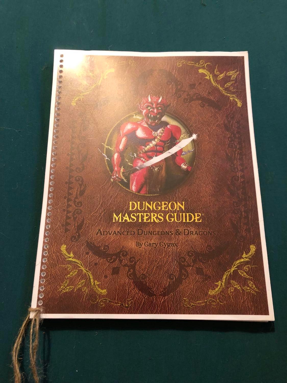 The first edition Dungeon Master's Guide, with the first strand of binding tied in