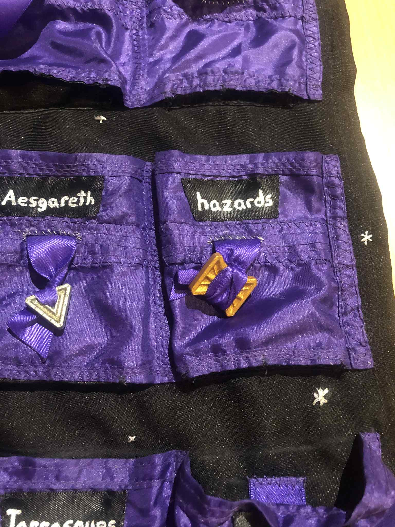 The front of the sleevesheet, with the labels now attached and several of the sparkly stars showing. Some of them are made as plus signs with four prongs in the asterisk star, and some are six prong, though there is also a five and seven prong star on the sheet, though not in the picture.