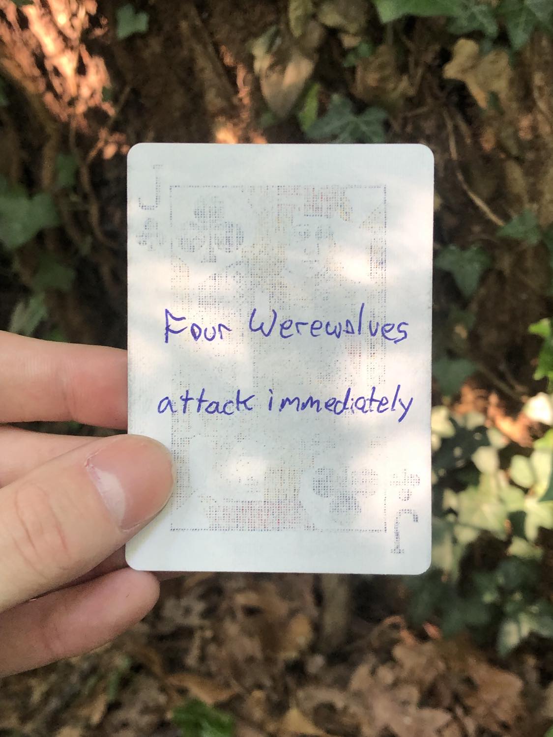 The jack of clubs, held above the detritus on the ground. Four Werewolves attack immediately.