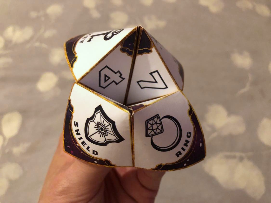 A paper fortune teller, what a curious device! Held and ready to bring you your future.