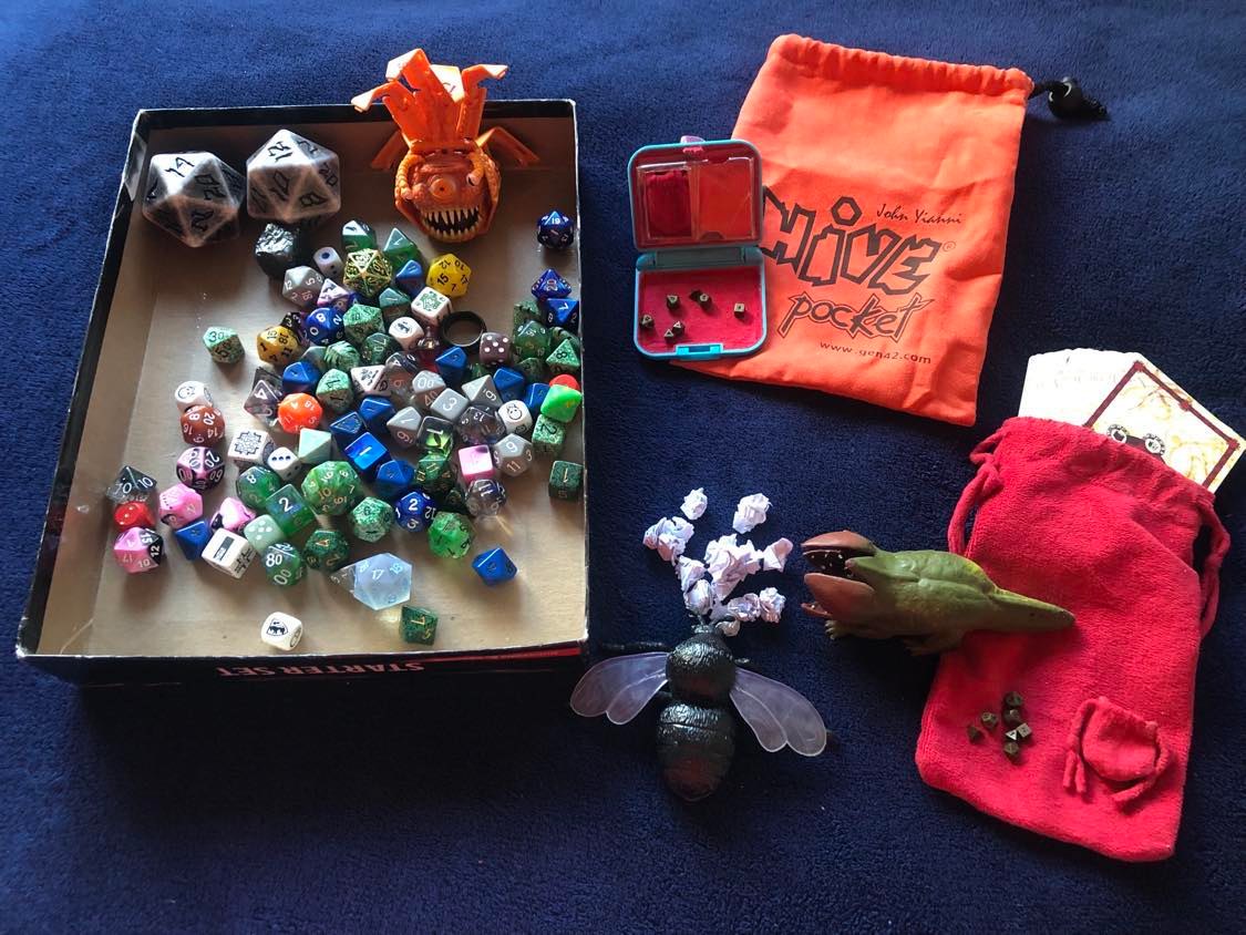 The full dice collection, with Simon and Lotus seen munching on scrap paper pieces in the middle.